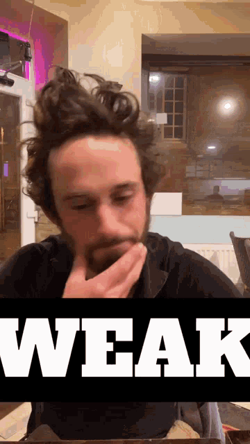 a man with a beard is covering his mouth with his hand and the word weak is behind him