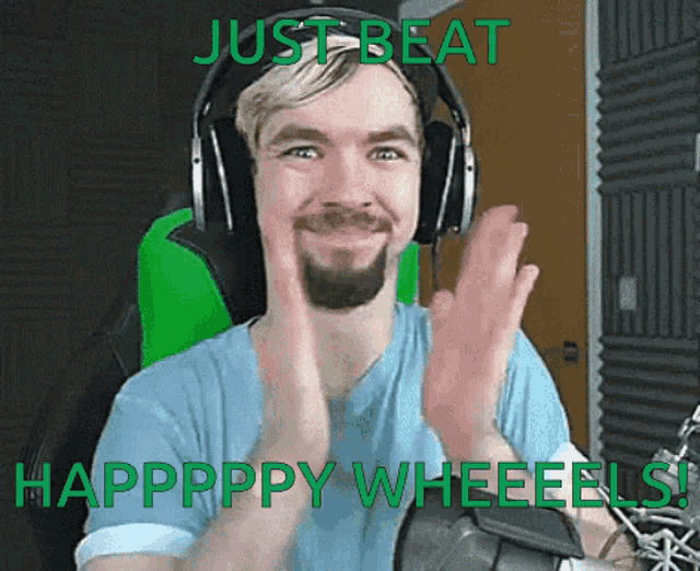 a man wearing headphones and a blue shirt says just beat happpppy wheelels