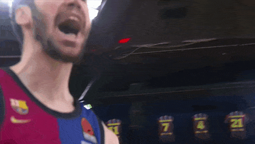 a man wearing a basketball jersey with the number 21 on the back
