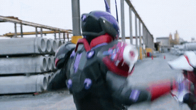 a person in a superhero costume is fighting another person .
