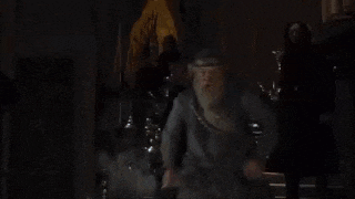 a close up of harry potter wearing glasses and a tie .