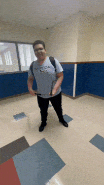 a man wearing a nautica shirt is holding a sword