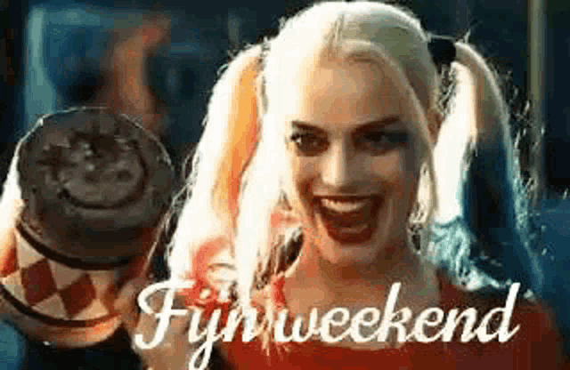 harley quinn from the movie suicide squad is holding a cup of coffee and smiling .