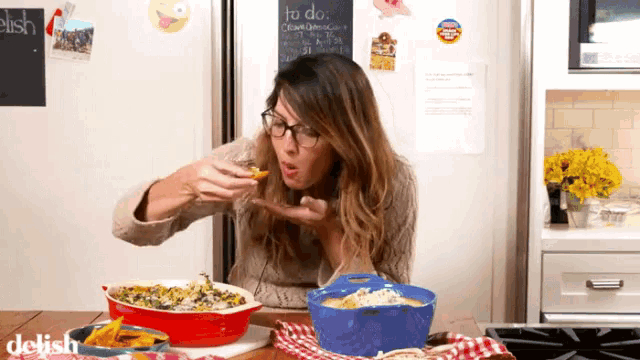 a woman eating food in front of a chalkboard that says to do on it