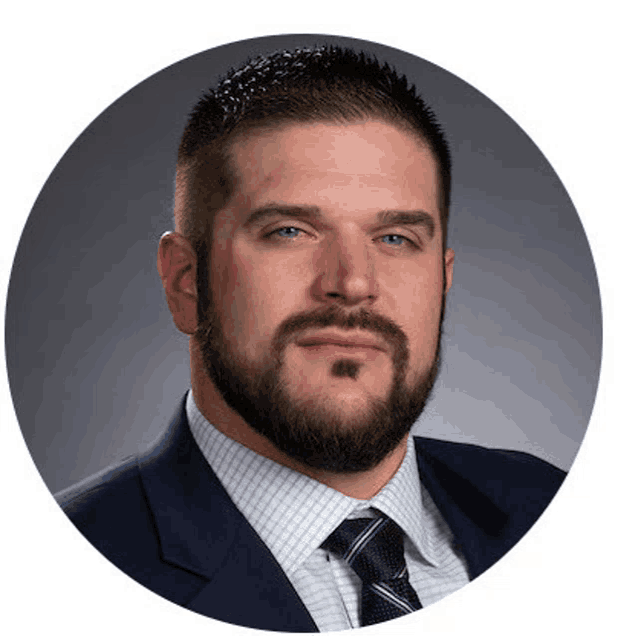 a man with a beard and mustache wearing a suit and tie