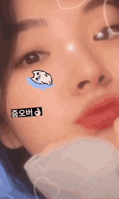 a close up of a woman 's face with a sticker on her face that says ' a ' on it