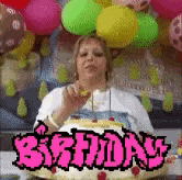 a woman is eating a birthday cake in front of balloons .