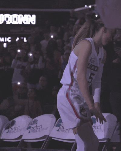 a basketball player wearing a white jersey that says conn on it