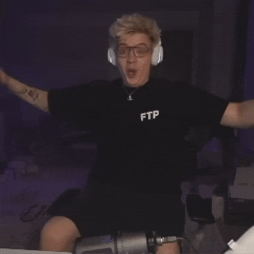 a man wearing headphones and a black shirt that says ptt on it