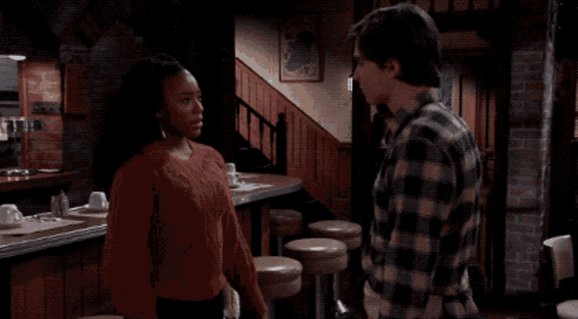 a man and a woman are looking at each other