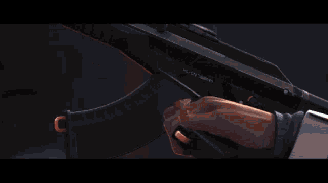 a close up of a person holding a gun in their hand