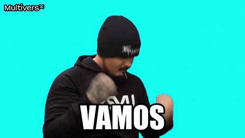 a man wearing a black hat and a black hoodie with the word vamos written on it