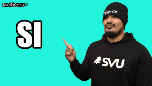 a man wearing a beanie and a sweatshirt that says svu points to the word si