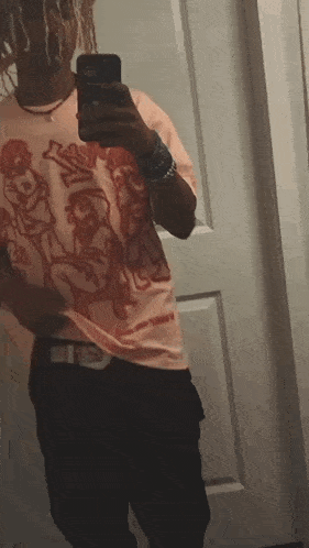 a man is taking a selfie in front of a mirror with his phone