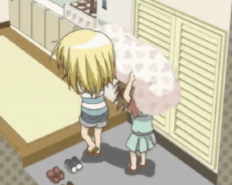 a couple of girls standing next to each other holding a blanket