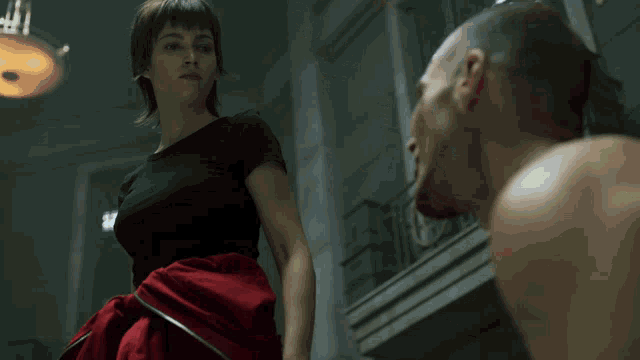 a woman in a red dress is holding a piece of meat