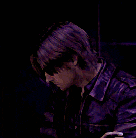 a man in a purple shirt is looking down