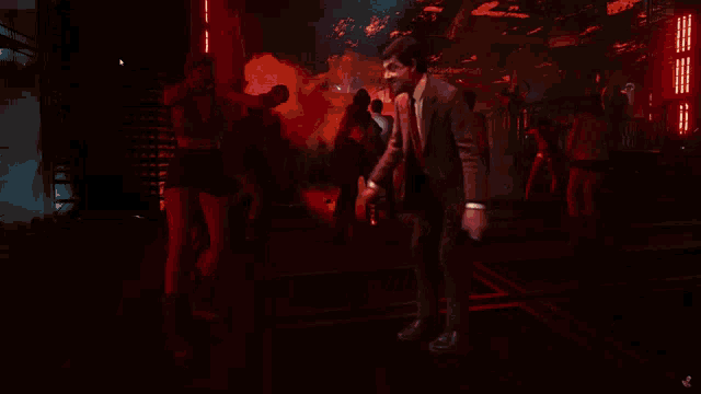 a man in a suit and tie is dancing in a club