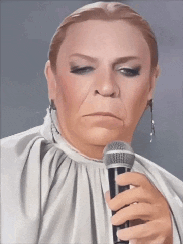 a woman in a white dress holds a microphone in her hand
