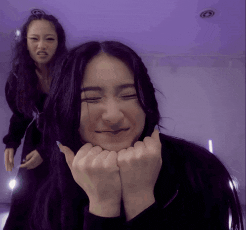 a woman making a face with her hands on her face