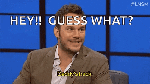 a man in a suit is talking on a television show and says `` hey ! guess what ? daddy 's back ''