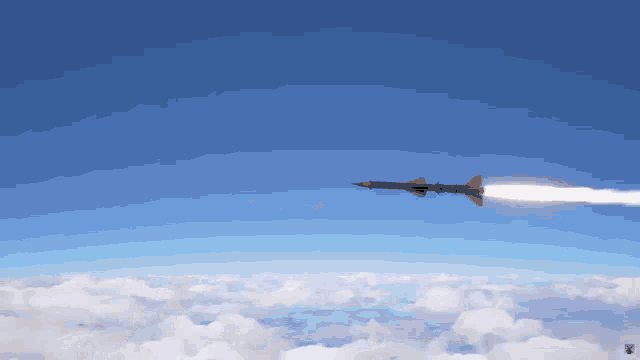 a rocket is flying through the air with a flame coming out of it