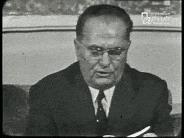 a black and white photo of a man in a suit and tie with the caption programski arkhiv