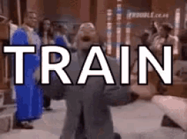 a man is kneeling down in front of the word train .