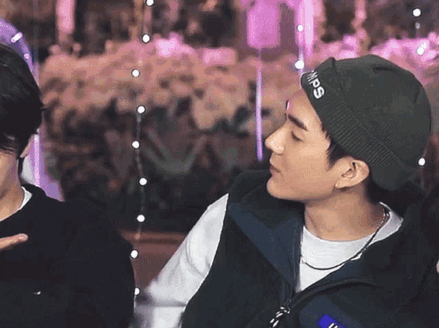 a man wearing a beanie that says supreme on it