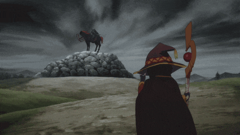 a man in a witch hat stands in front of a horse statue