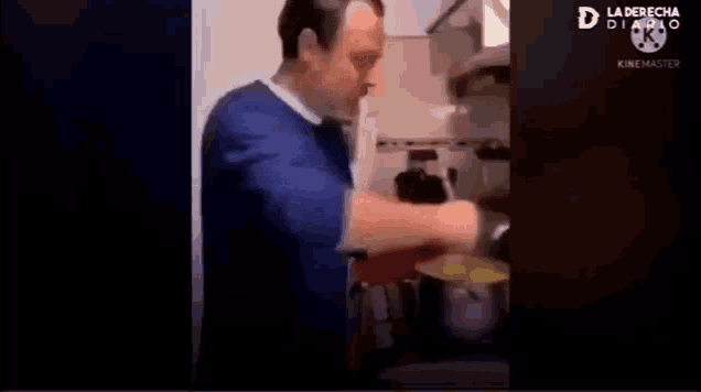 a man is cooking in a kitchen with a pot and a pan and says polenta a full eh .