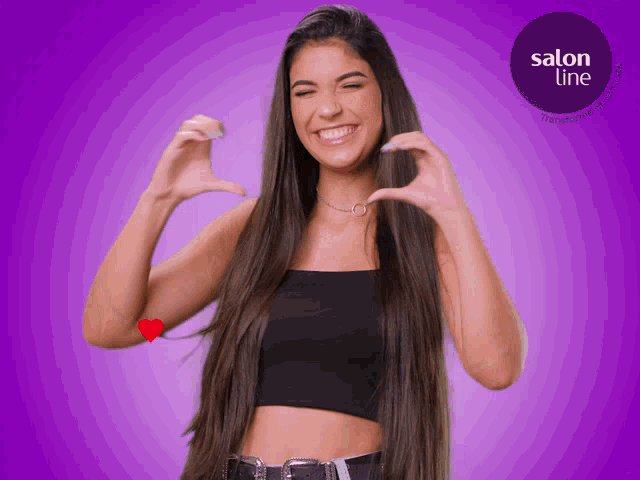 a woman with long hair making a heart with her hands in front of a salon line logo
