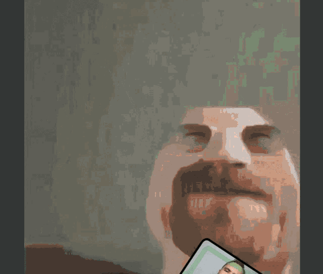 a man with a beard is holding up a green card that says work