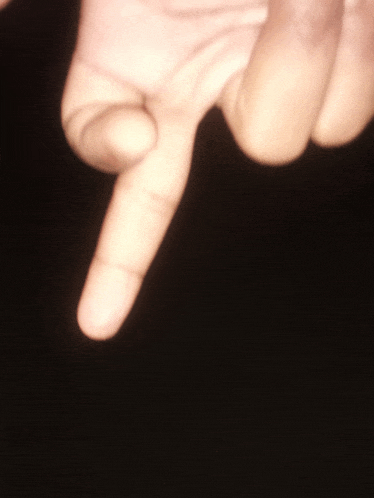 a close up of a person 's thumb pointing to the left