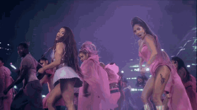 ariana grande and lady gaga are dancing on stage