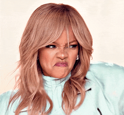 a close up of a woman making a face