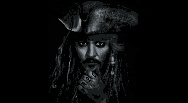 a man with dreadlocks and a pirate hat is standing next to a woman .