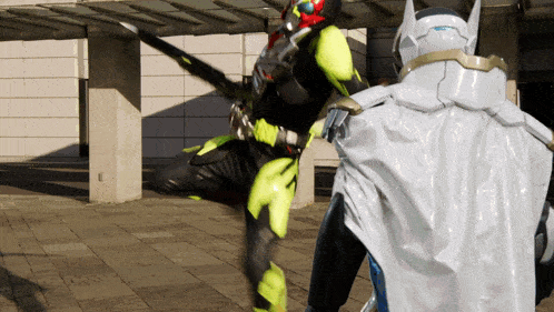 a man in a white cape is standing next to a man in a black and yellow costume