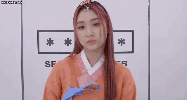 a girl with pink hair is standing in front of a sign that says sf on it
