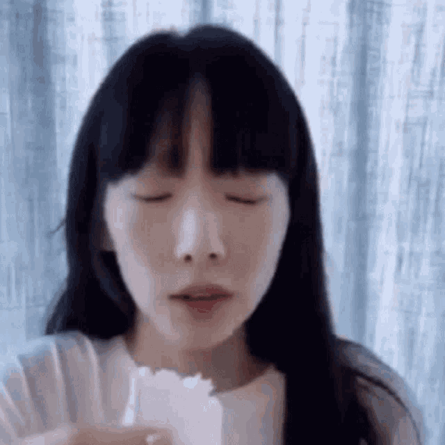 a close up of a woman eating a piece of bread .