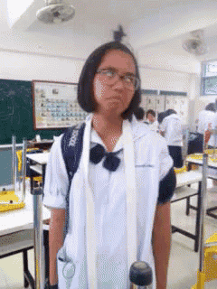 a girl in a classroom with a backpack that says brooks on it