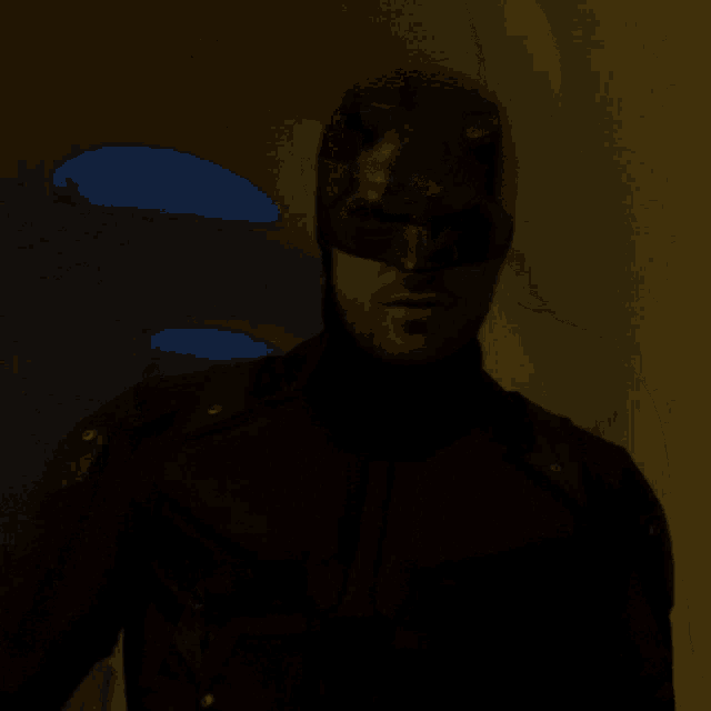 a man wearing a helmet and sunglasses looks at the camera