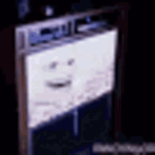 a blurred image of a stove top oven with a face on it