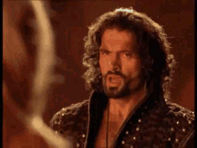 a man with a beard is talking to another man and says call me what you will