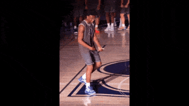 a basketball player stands on a court wearing a jersey that says nba on it