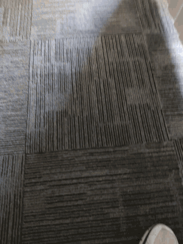 a gray rug with a pattern of squares and lines
