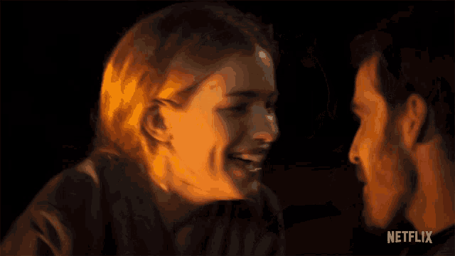 a man and a woman are looking into each other 's eyes with a netflix logo in the background