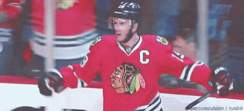 a hockey player is wearing a red jersey with the letter c on it