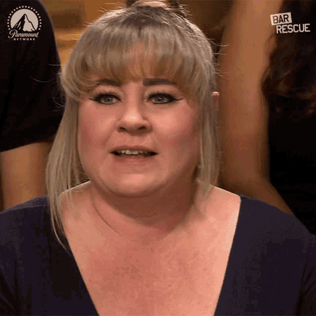 a woman is sitting in front of a screen that says bar rescue