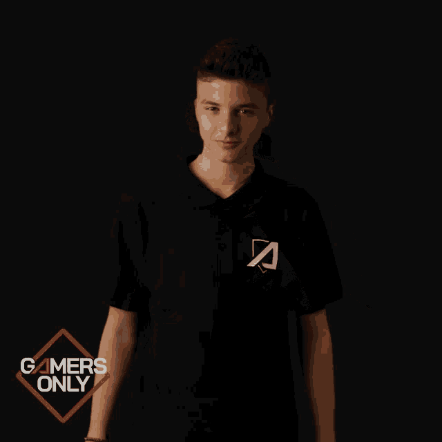 a boy wearing a black shirt with the letter a on the front